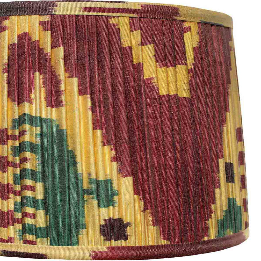 Close-up of the maroon and multicolour ikat design on Mekhann's lampshade, highlighting the artisanal dyeing technique and detail.