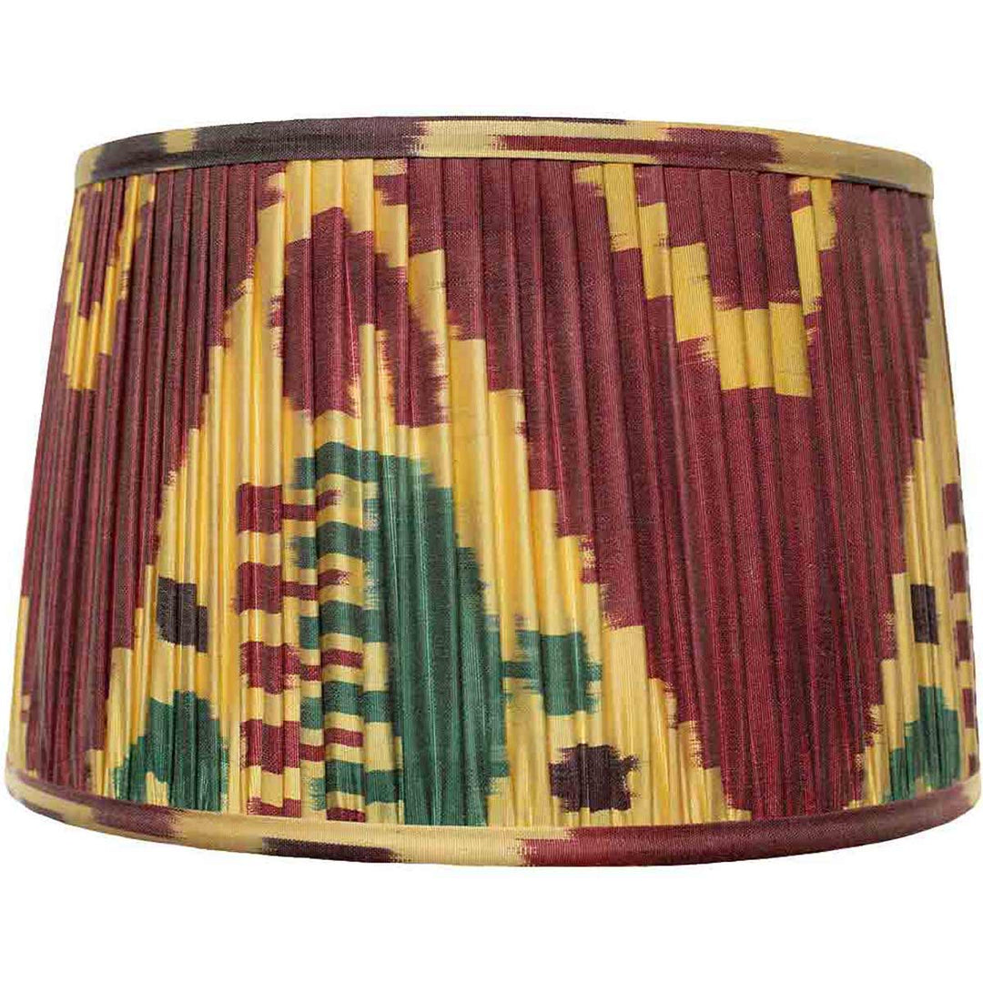 Front view of Mekhann's maroon multicolour ikat silk lampshade, hand-pleated with vibrant, sustainable dyes for a rich decor statement.