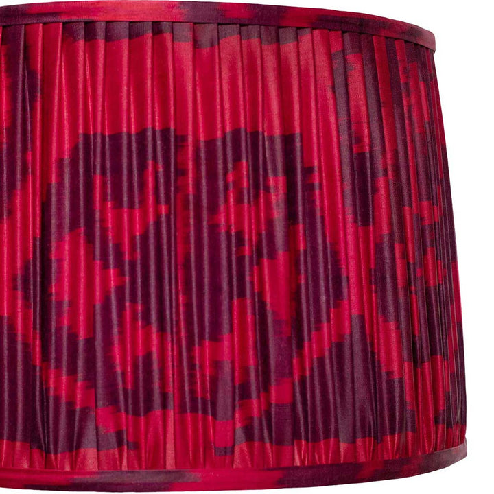 Close-up of Mekhann's maroon silk lampshade, featuring detailed ikat patterning and meticulous artisan pleating.