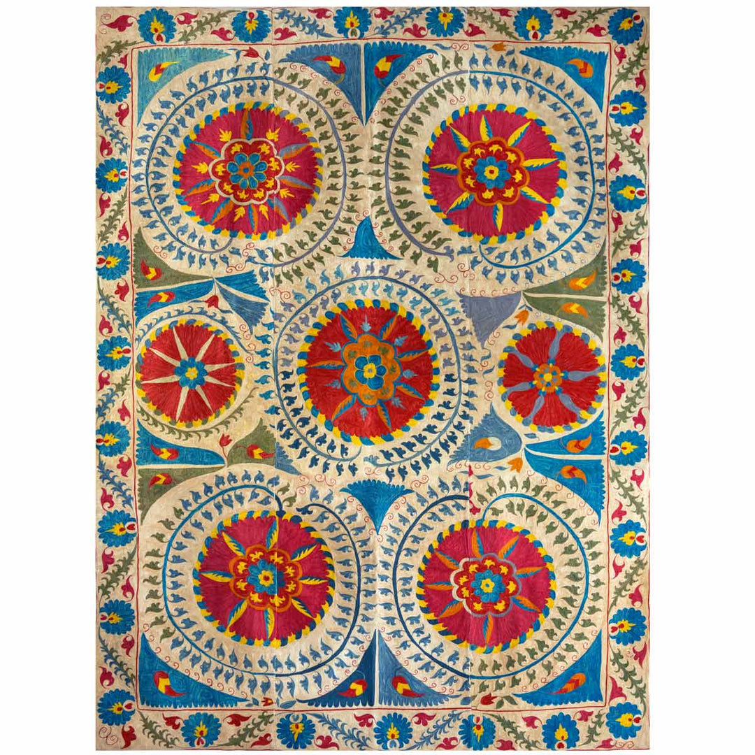 Front view of Mekhann's multicoloured medallion throw,  showing the full grand composition of the medallion throw. The throw is fully embroidered with silk threads with the main colours being bright blue, red, green and hints of yellow..