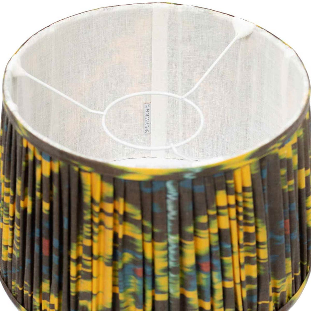 Interior shot of Mekhann's colourful ikat lampshade, displaying the luxurious silk texture and rich, plant-based dye hues.