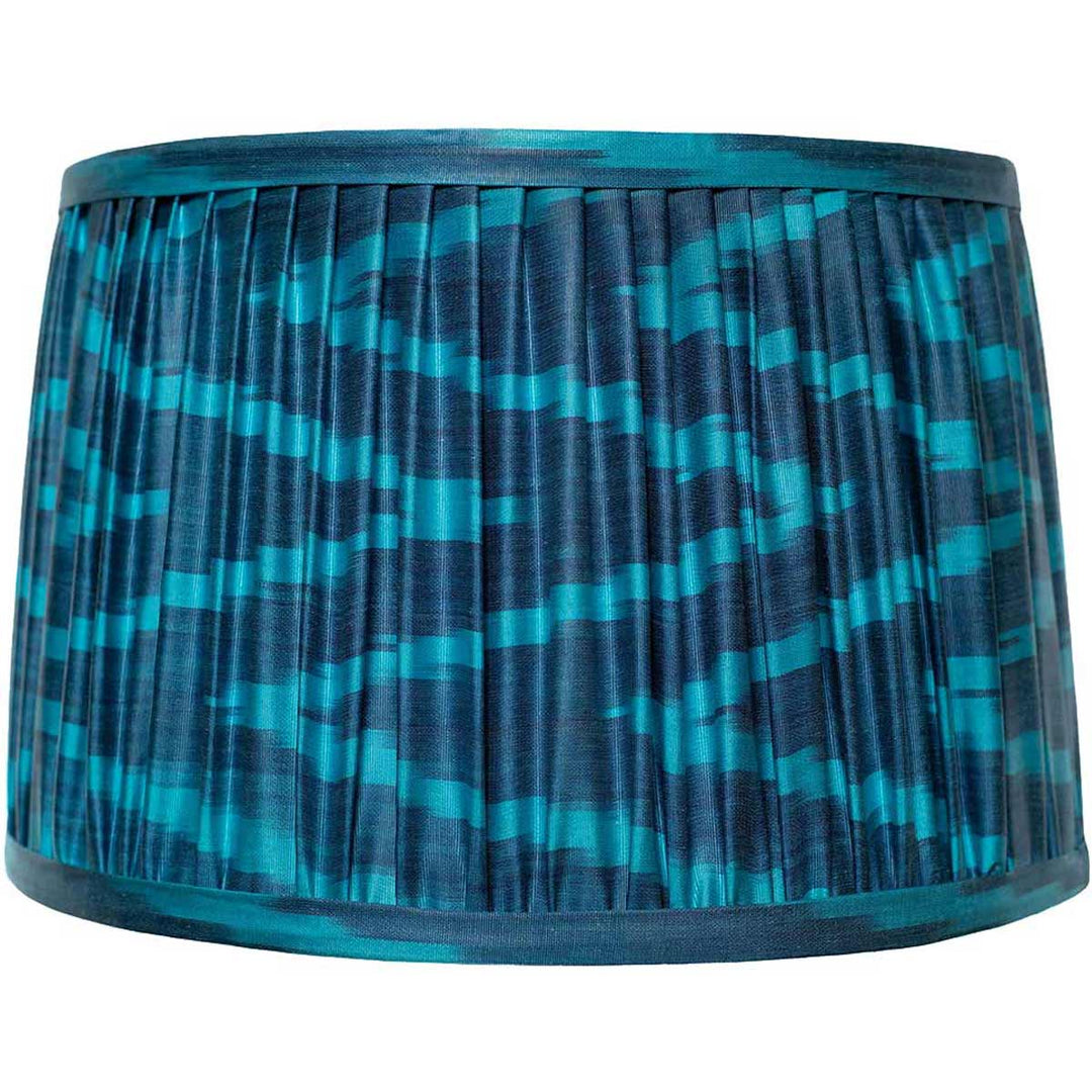 Front view of Mekhann's navy blue silk ikat lampshade, showcasing the elegance of hand-pleated design with natural dyes.