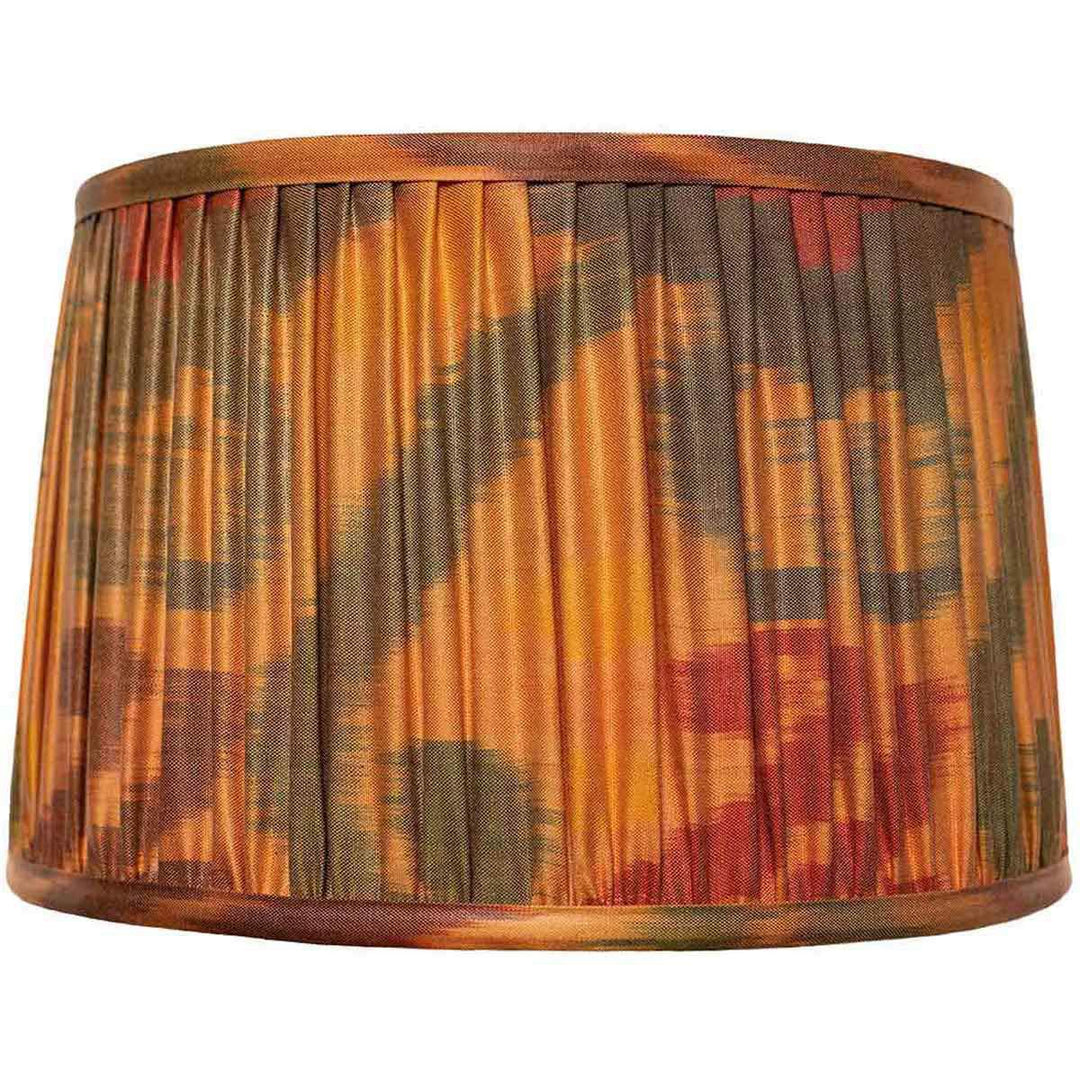 Front view of Mekhann's orange ikat silk lampshade, displaying a hand-pleated design with natural, vibrant dyes.