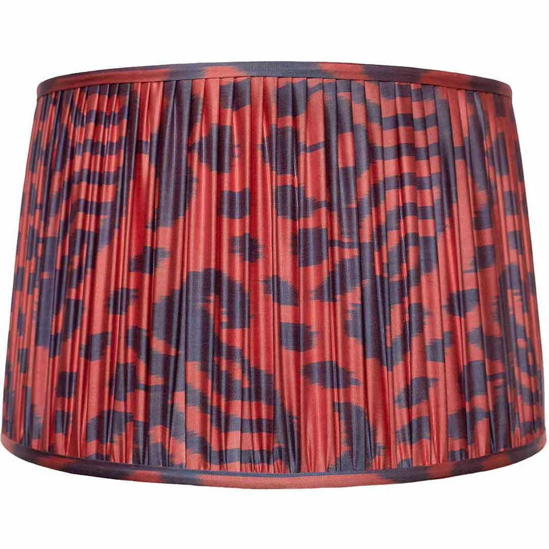 Front view of Mekhann's red and navy patterned ikat silk lampshade, handcrafted with precision pleating and natural dyes.