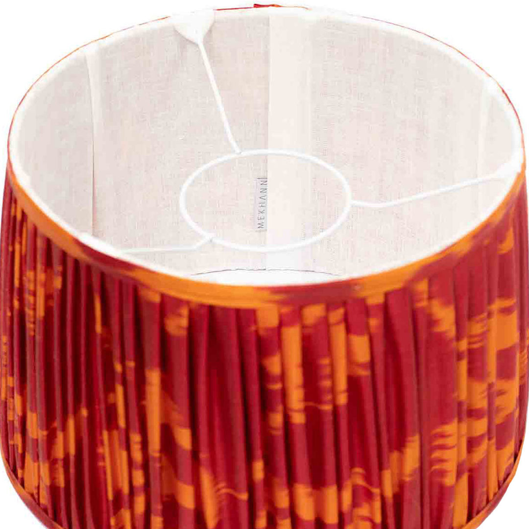 Interior shot of Mekhann's red and orange ikat lampshade, revealing the vibrant silk craftsmanship and dynamic colouring.