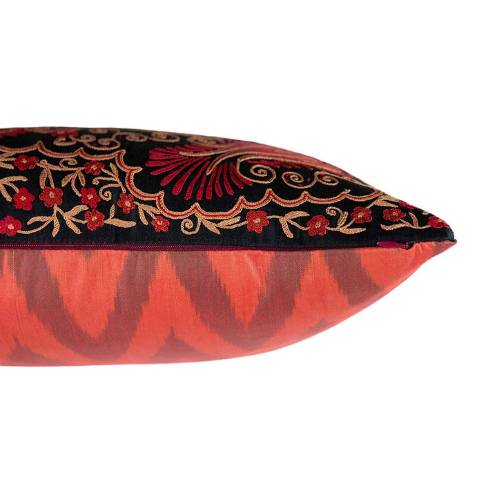 Side view of Mekhann's red and black iznik embroidered cushion. We can see where the front black silk layer meets the red and maroon ikat back lining.
