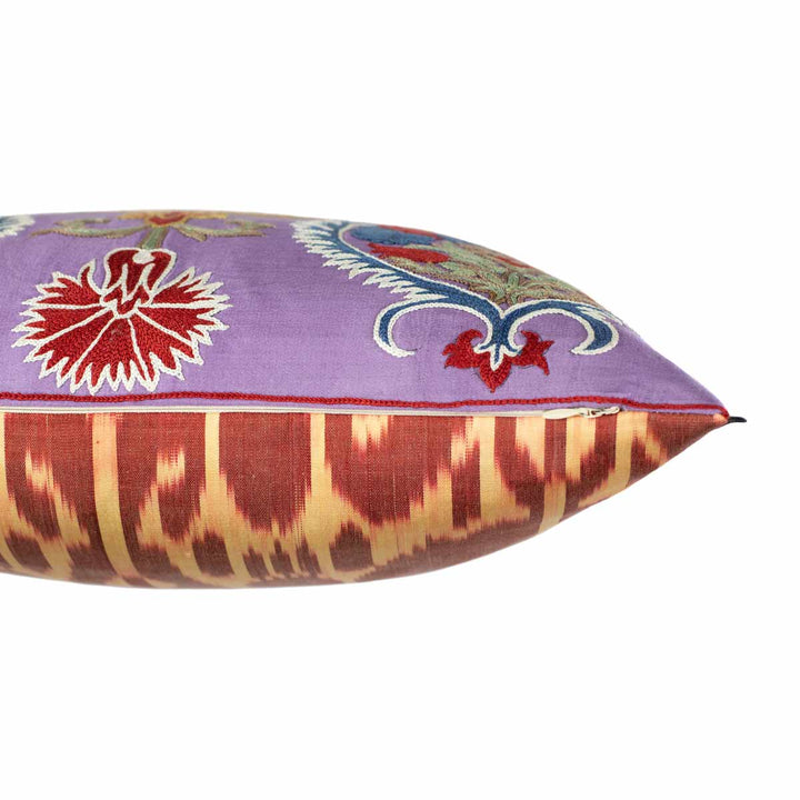 Side view of Mekhann's multicoloured Topkapi embroidered cushion, showing where the purple silk front player meets the ikat back layer of the cushion.
