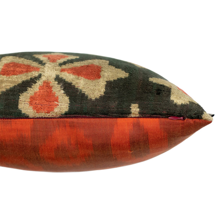 Side view of Mekhann's black and orange velvet cushion, revealing the side zip of the cushion that is used for the adding or removal of a cushion pad.