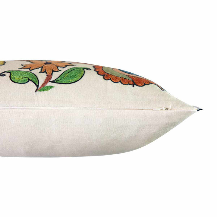 Side view of Mekhann's cream Tulips and Pomegranates embroidered cushion, showing how the cream front and back of the cushion seamlessly come together.