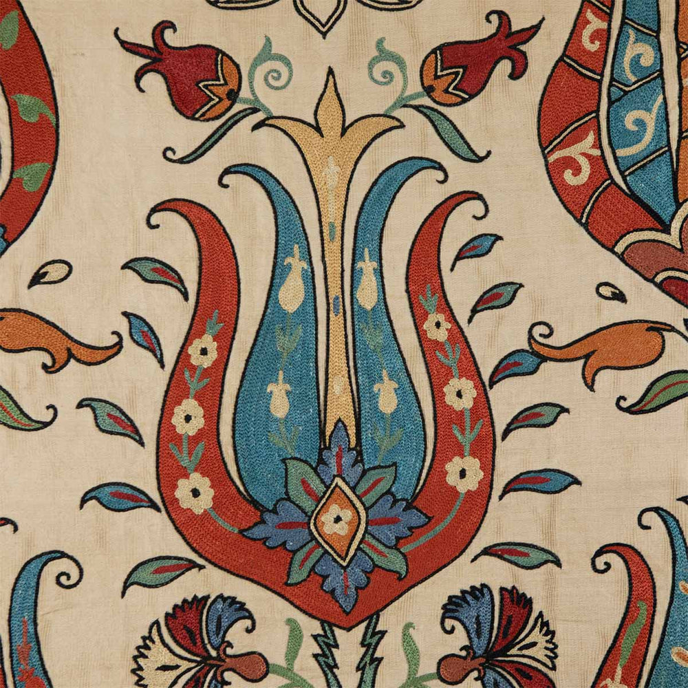 Close-up of the intricate tulip embroidery on Mekhann's silk throw, displaying rich colours and exquisite detail for a classic aesthetic.