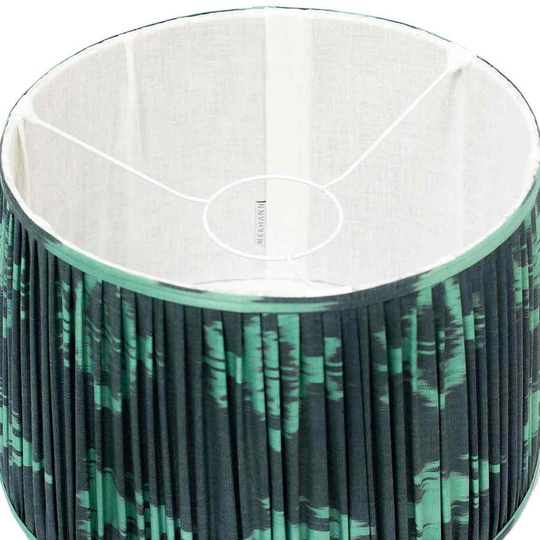 Interior view of Mekhann's handcrafted teal ikat silk lampshade, revealing the meticulous detail of the artisanal dye work.
