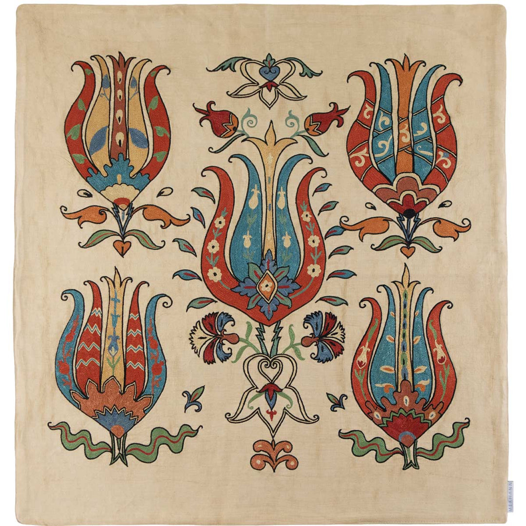 Mekhann silk throw featuring traditional tulip embroidery in red, blue, and green on a natural silk background, perfect for luxury interiors.