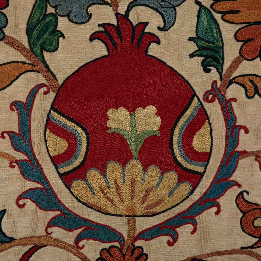 Detailed view of Mekhann's silk tulip petite throw, highlighting the intricate embroidery and vibrant colour palette.