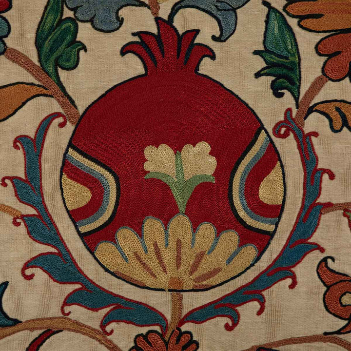 Detailed view of Mekhann's silk tulip petite throw, highlighting the intricate embroidery and vibrant colour palette.