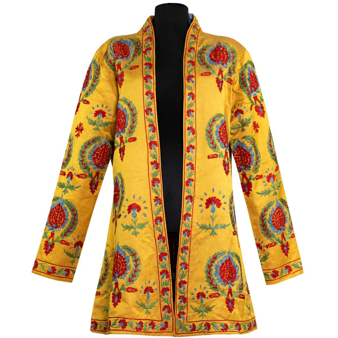 Front view of Mekhann's embroidered arabesque kaftan in saffron, adorned with blue and red hand embroidered arabesque patterns on a silk saffron base.