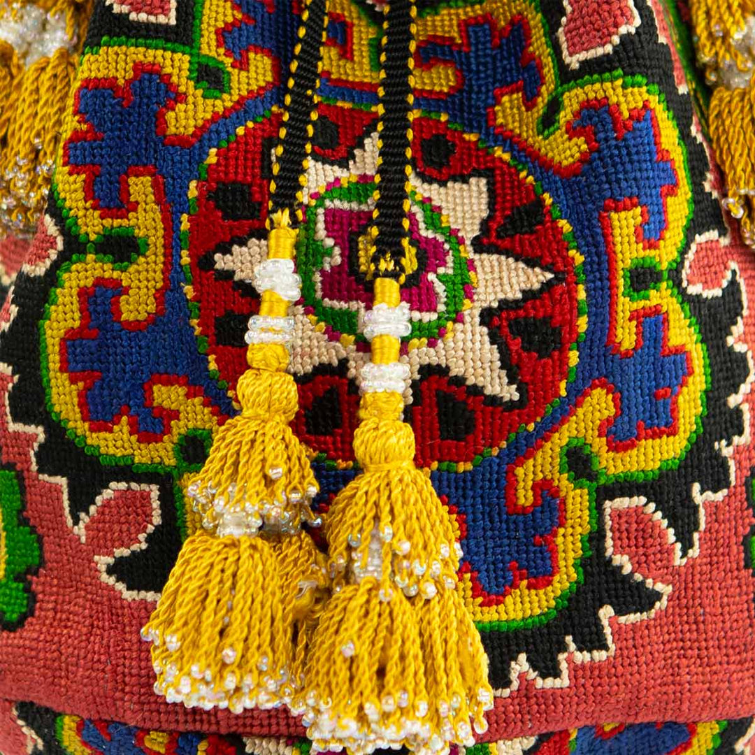 Close-up of the intricate embroidery on Mekhann's arabesque clementine bucket bag, highlighting the detailed craftsmanship and vibrant colour mix.