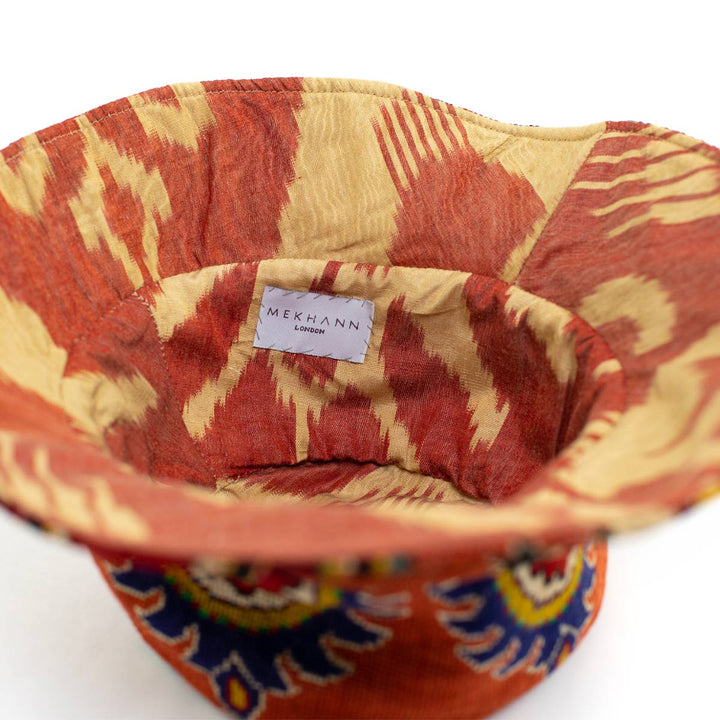 Full frame view of the arabesque clementine bucket hat, showing the full lower display of the hat and showing the flaps of the hat.