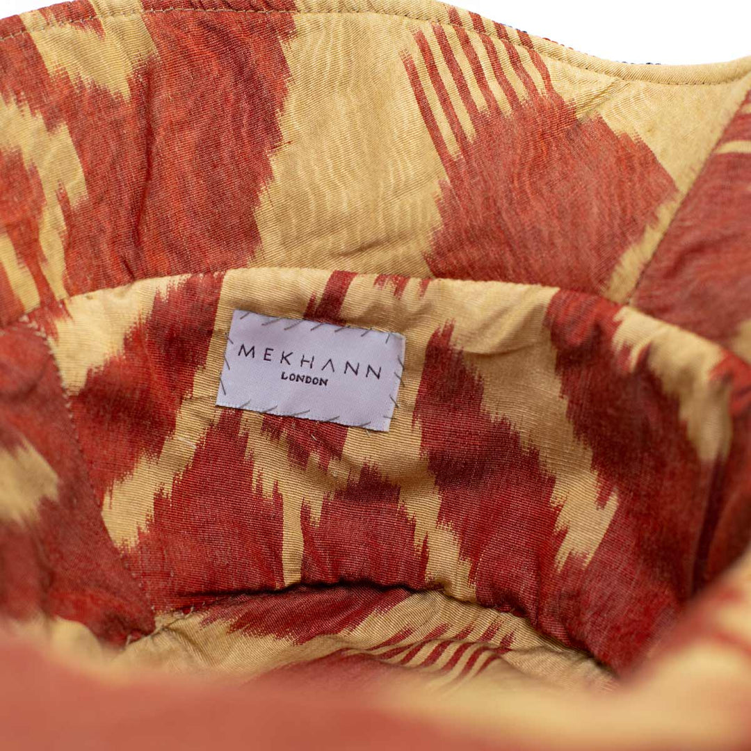 Inside view of the arabesque clementine bucket hat, revealing a wonderful ikat lining to durability and comfort.