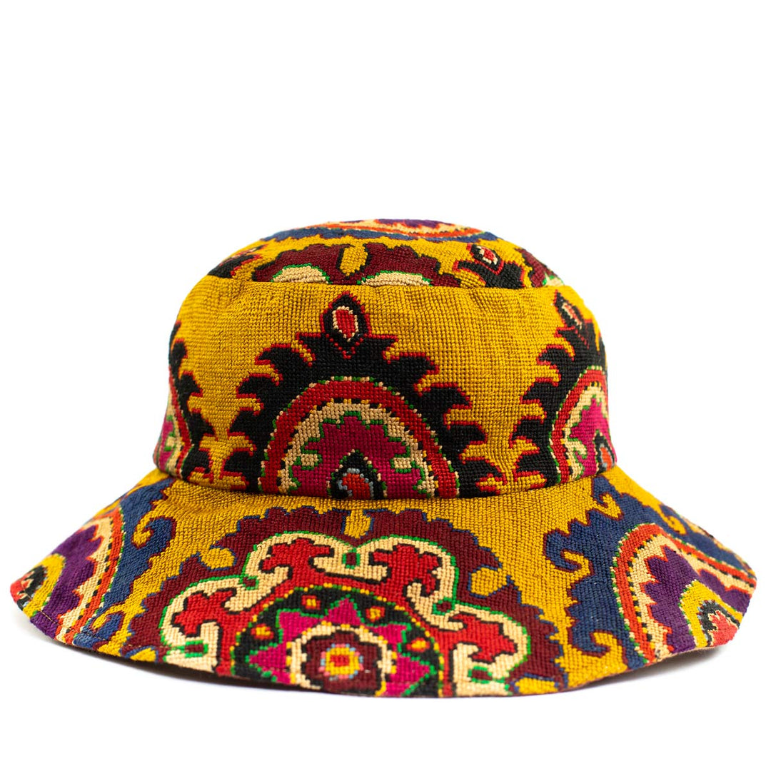 Front view of the arabesque yellow bucket hat, displaying a bright range of embroidered patterns.