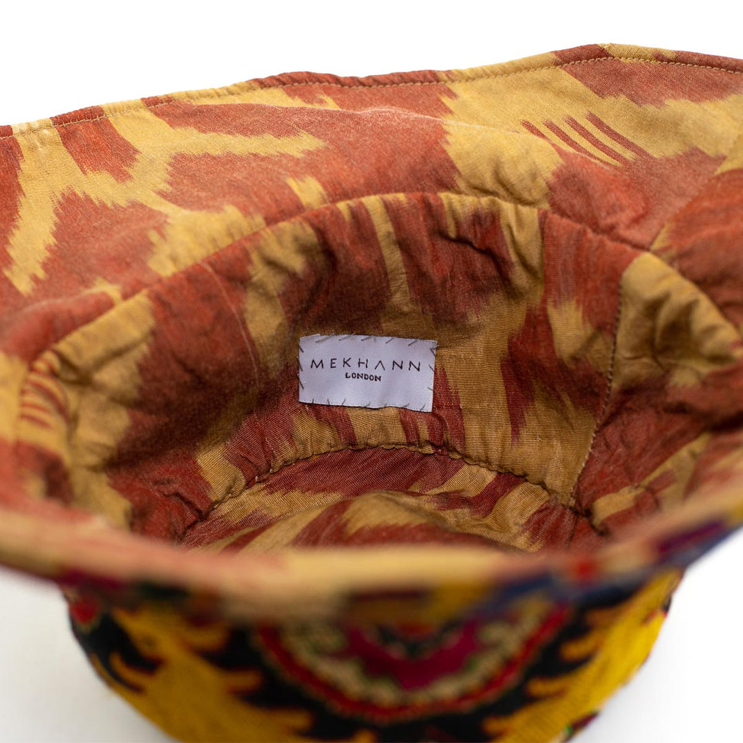 Full frame view of the arabesque yellow bucket hat, showing the full view of the inside of the bucket hat.