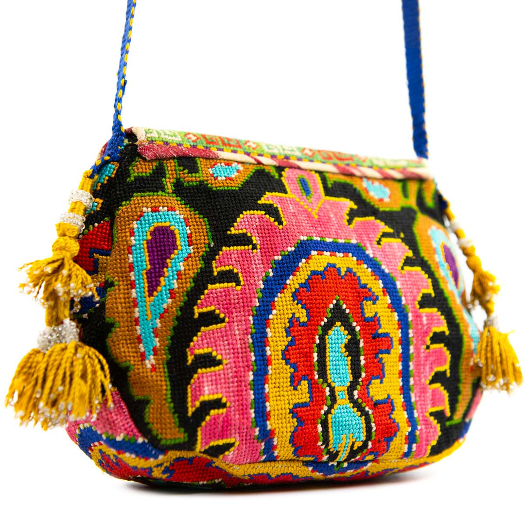 Back view of Mekhann's black and multicoloured arabesque embroidered cross-body bag, displaying how they design pattern spreads consistently onto the back of the bag as well as the front.