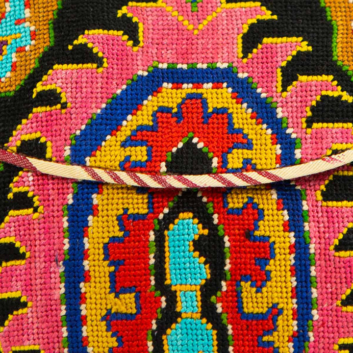 Close up view of Mekhann's black and multicoloured arabesque embroidered cross-body bag, giving a closer view of the craftsmanship detailing.