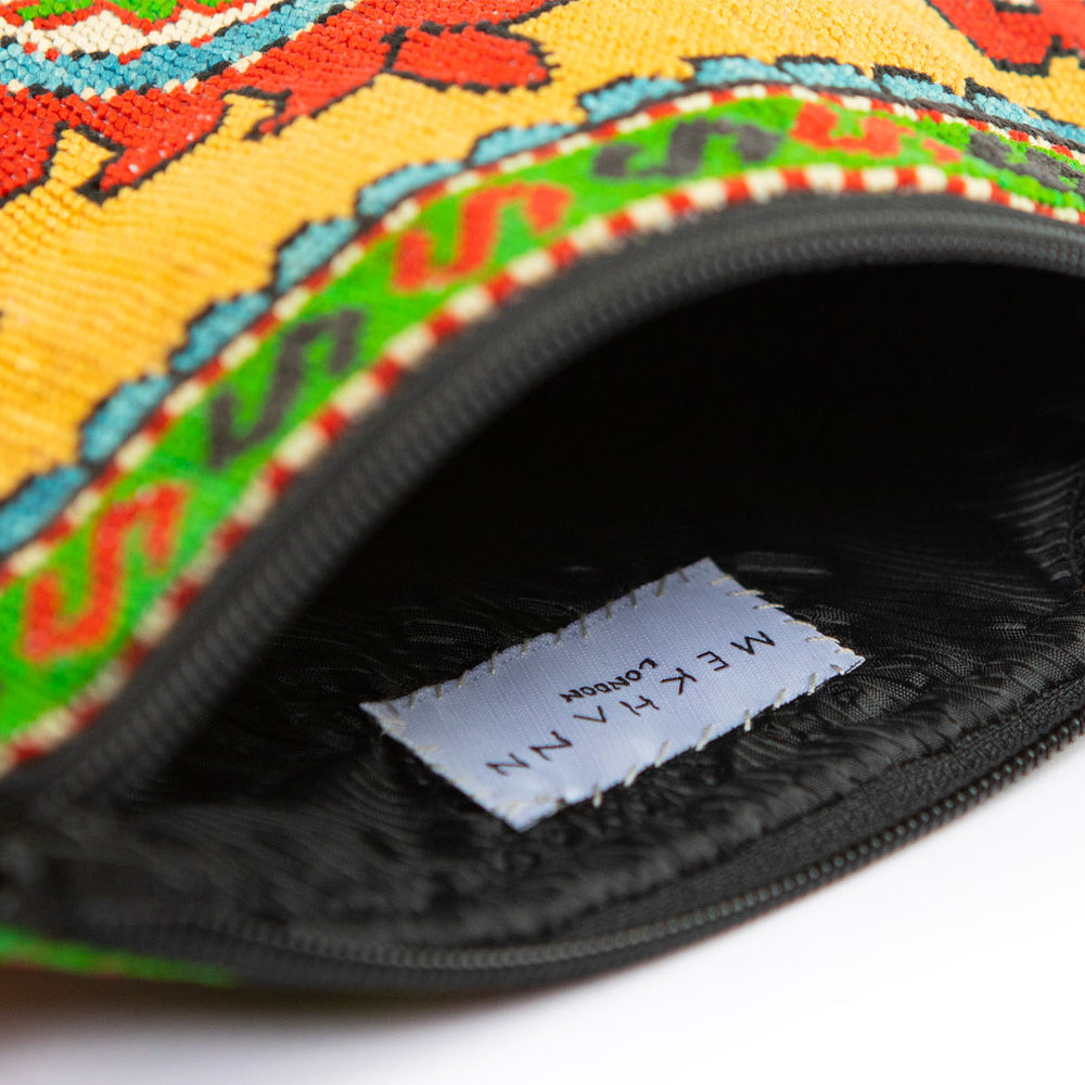 Inside view of Mekhann's multicoloured arabesque embroidered cross-body, showing its durable black interior lining. 