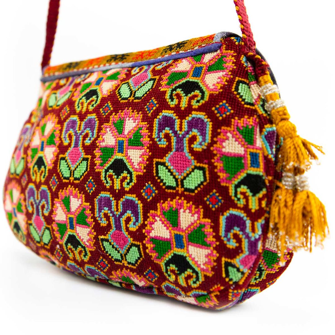 Back view of Mekhann's arabesque embroidered cross-body bag, highlighting the diverse patterns that spread all over the bag.