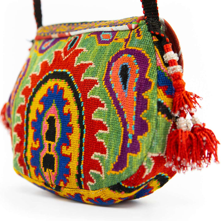 Back view of Mekhann's green arabesque embroidered cross-body bag, showing the consistency in the design all over the bags surface.