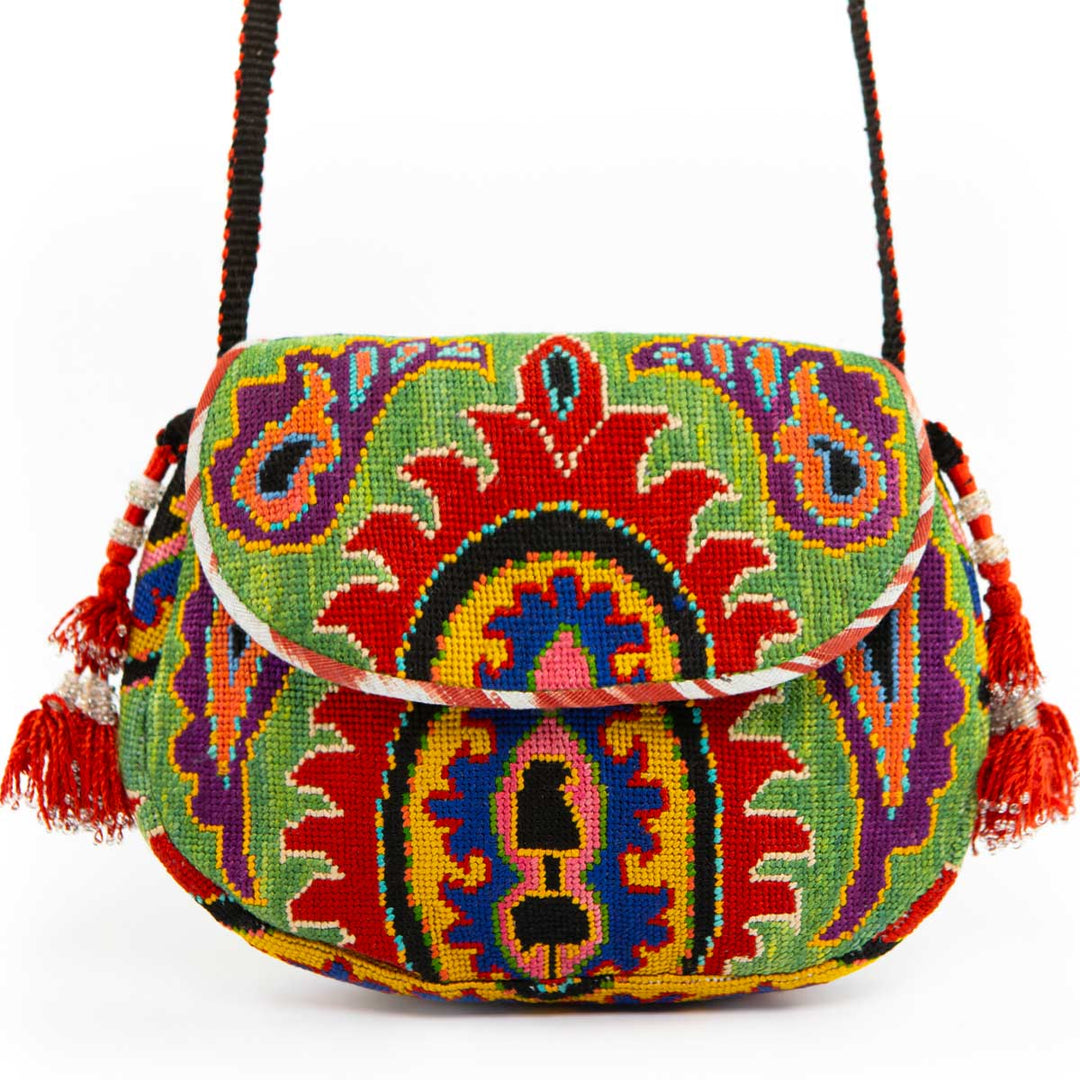 Front view of Mekhann's green arabesque embroidered cross-body bag, showcasing it's red tassels and bold colours.