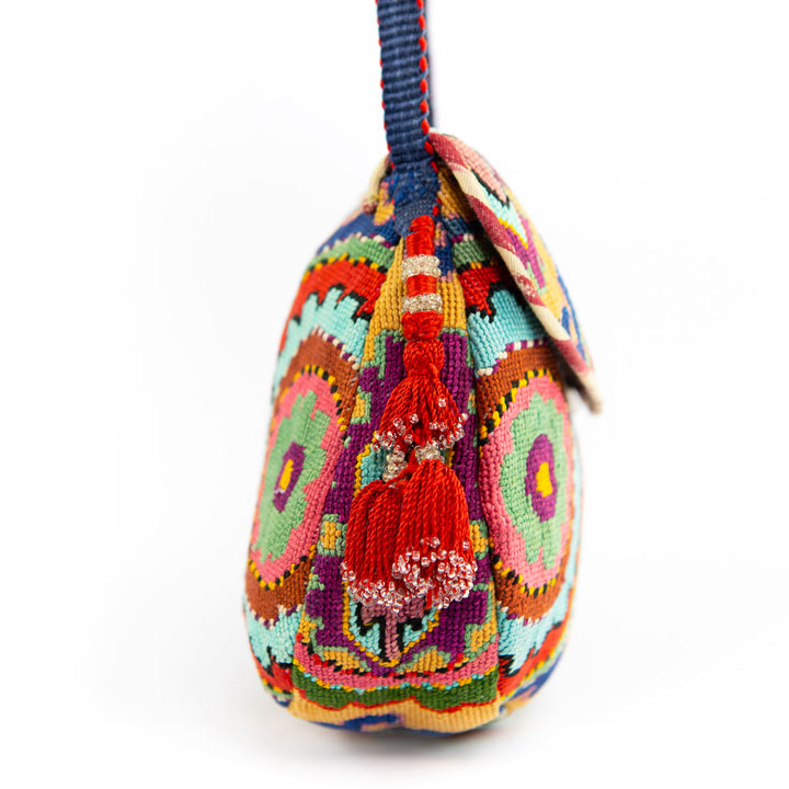 Side view of Mekhann's arabesque embroidered cross-body bag, illustrating the depth of the vibrant embroidery of the strap.