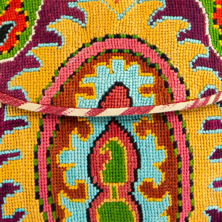 Close up view of Mekhann's yellow, purple and multicoloured arabesque embroidered cross-body bag, showing off the bright stitching details on the bag.