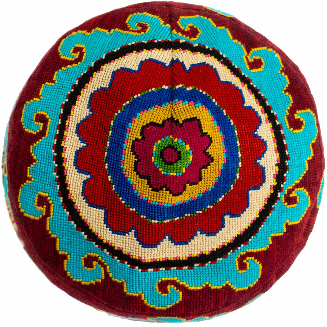 Top view of Mekhann's multicoloured arabesque skull cap, show casing the bright collection of colours inducing blues and maroons.