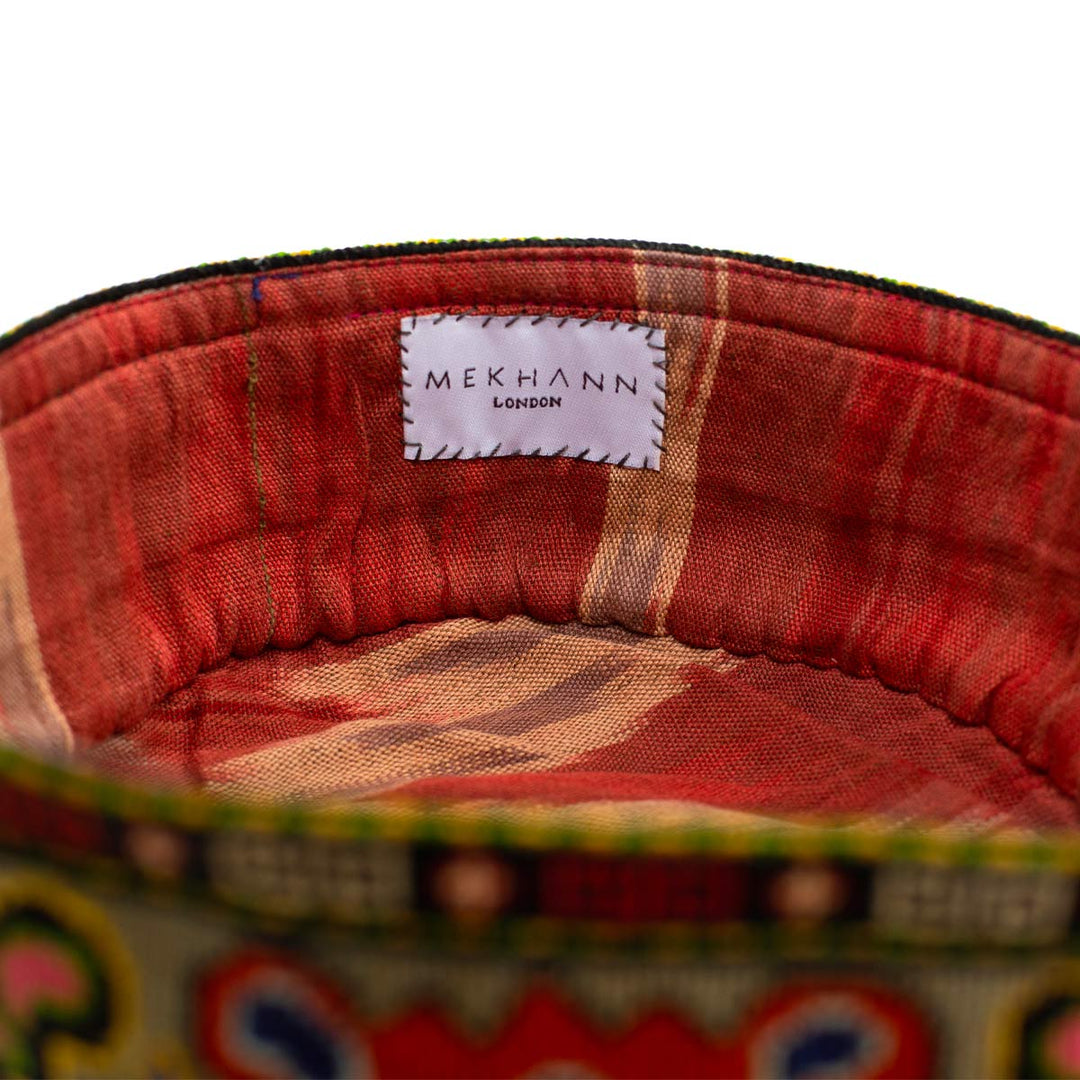Inside view of Mekhann's multicoloured arabesque skull cap, revealing a bold red ikat lining that has been chosen to offer you style and comfort.