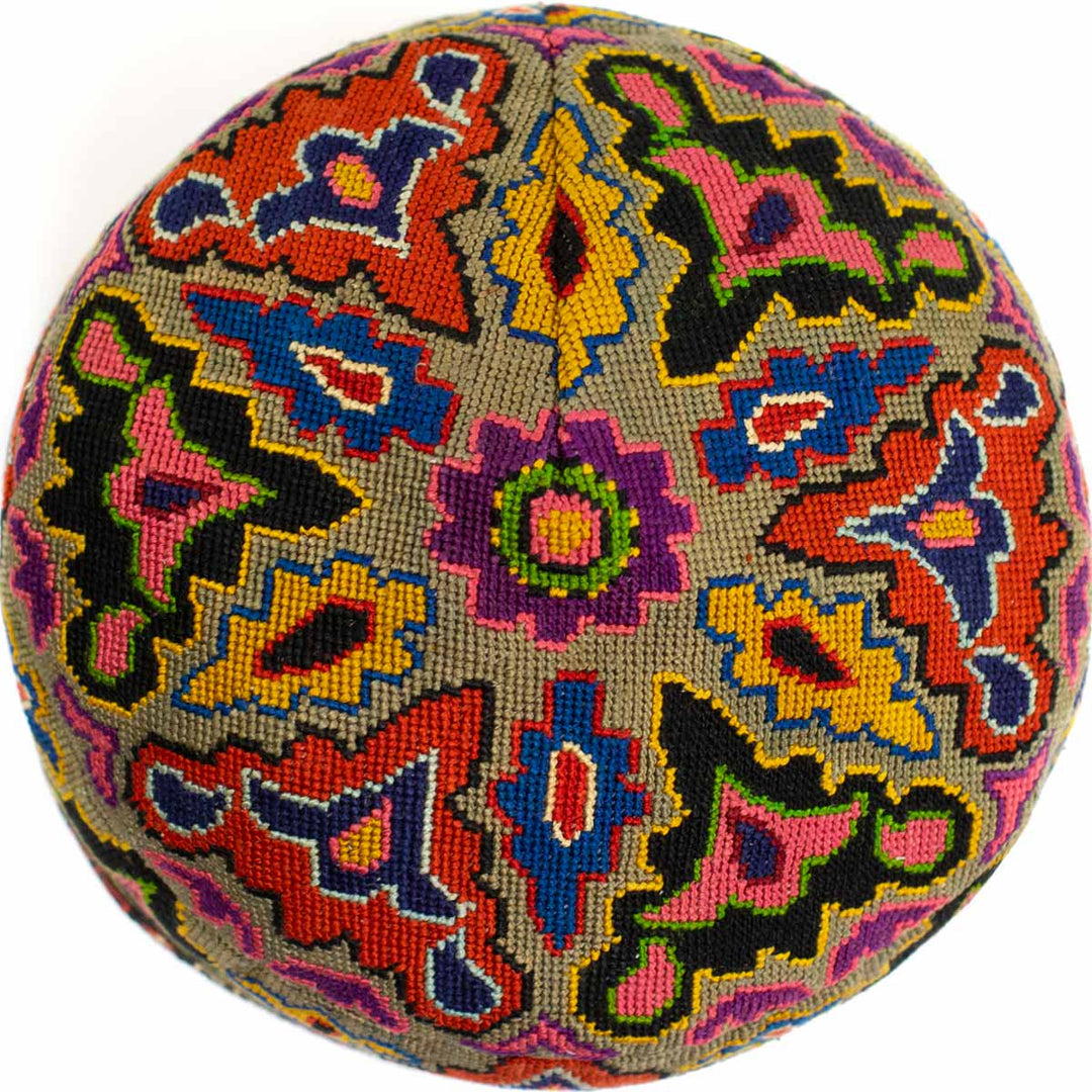 Top view of Mekhann's multicoloured arabesque skull cap, Showing off the beauty of the hand embroidered patterns covering the top on the skull cap.