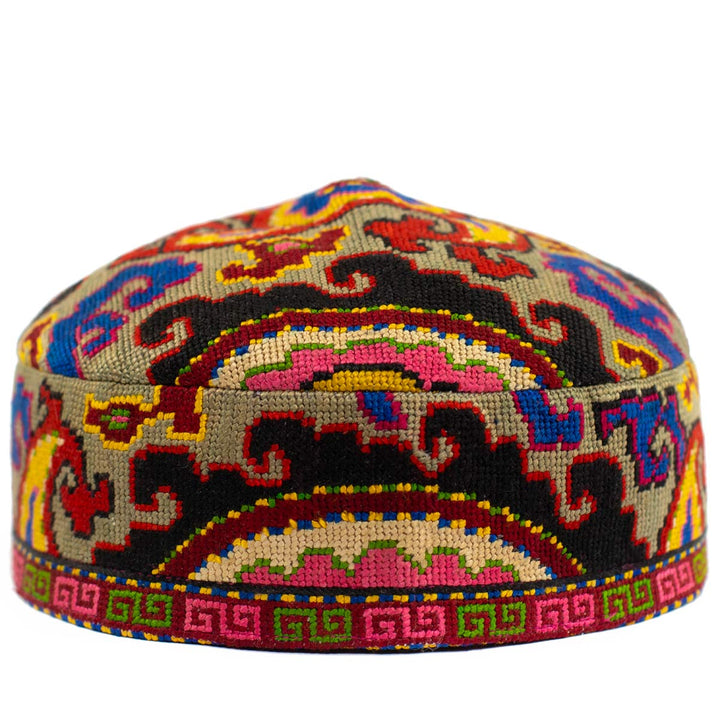 Front view of Mekhann's arabesque multicoloured skull cap, showcasing a display of embroidered patterns in pink, black, green and blue.