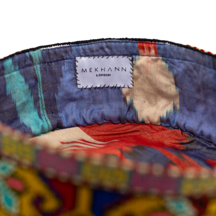 inside view of Mekhann's arabesque yellow skull cap, with it's colourful ikat lining on display used for it's durability and design.