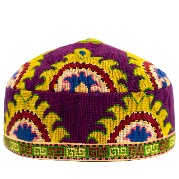 Front view of Mekhann's purple arabesque skull cap, showing a hand embroidered collection of patterns in yellow, green and blue on a base of vibrant purple.