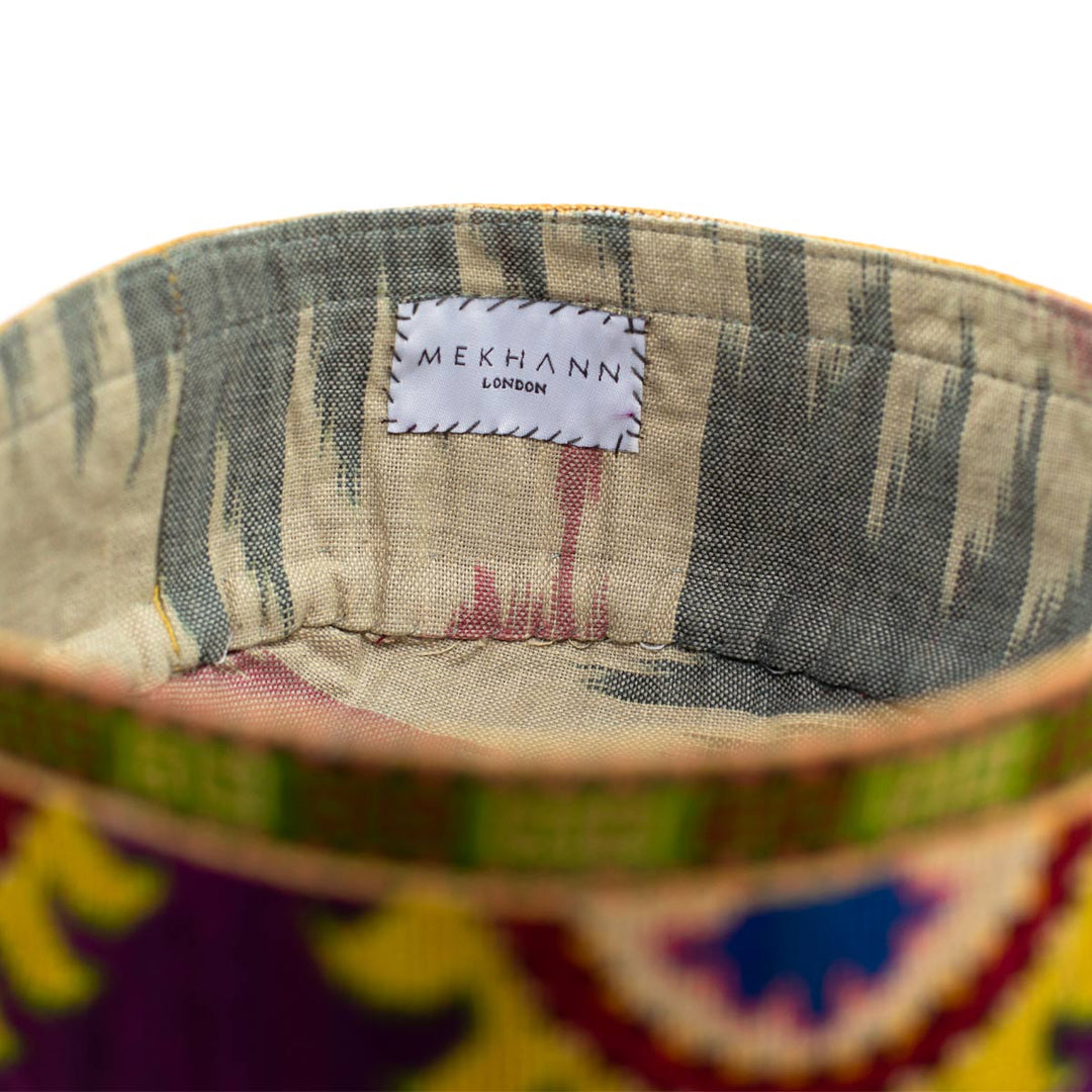 Inside view of Mekhann's purple arabesque skull cap, revealing a light ikat fabric to line the skull cap and give the user comfort.