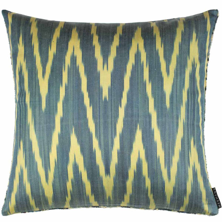 Back view of Mekhann's light green velvet cushion, showcasing a zigzag ikat pattern in blue and light yellow.