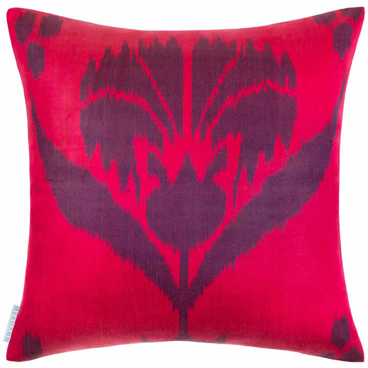 Back view of Mekhann's multicoloured abstract embroidered cushion, showing the bright pink ikat back lining of the cushion.