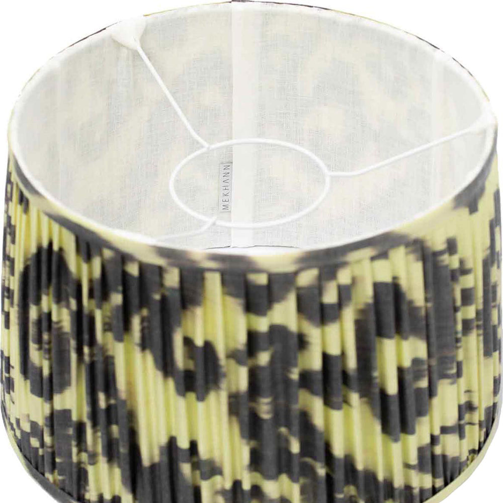 Interior shot of Mekhann's ikat lampshade, highlighting the silk's premium texture and striking black and lime pattern.