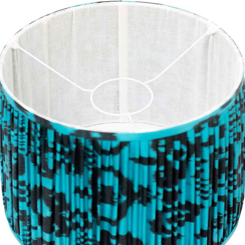 Interior view of Mekhann's ikat lampshade, highlighting the deep blue silk fabric and contrasting black ikat patterns.