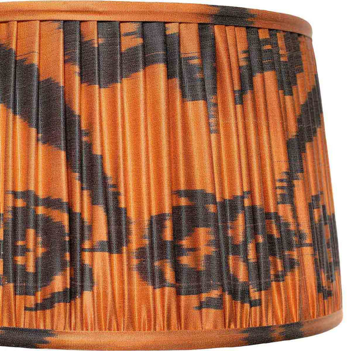 Close-up of the intricate black and orange ikat pattern on Mekhann's lampshade, emphasising the handcrafted details.