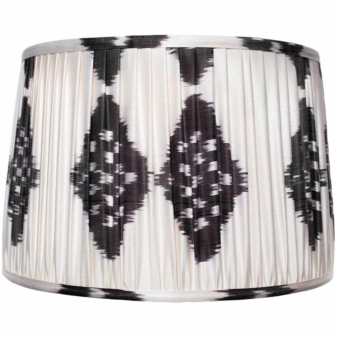 Front view of Mekhann's black and white ikat silk lampshade, hand-pleated to perfection with a bold, monochromatic pattern.