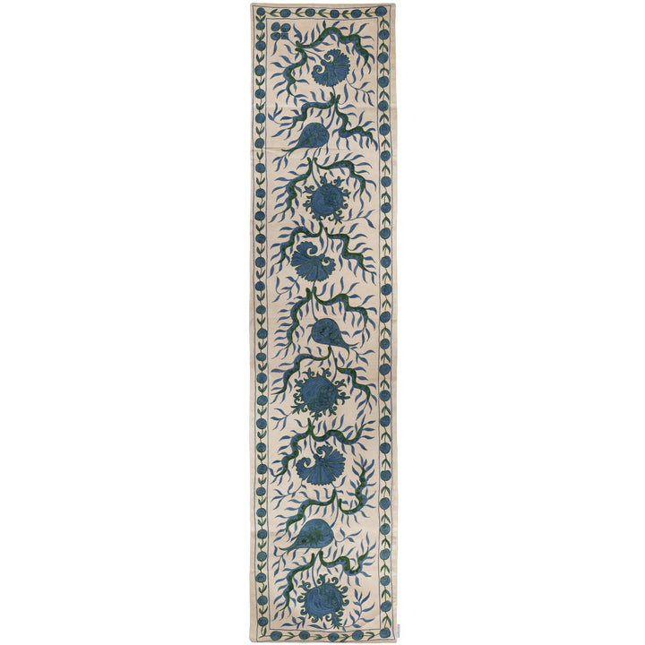 Front view of Mekhann's cream ottoman vines runner, featuring a blue Ottoman vines pattern that stretches the length of the runner all hand embroidered on a base of cream coloured silk.