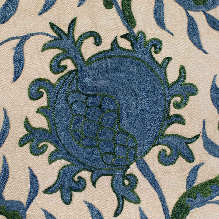 Close up view of Mekhann's cream ottoman vines runner, showing the detailed hand embroidered patterns on the cream silk backdrop.