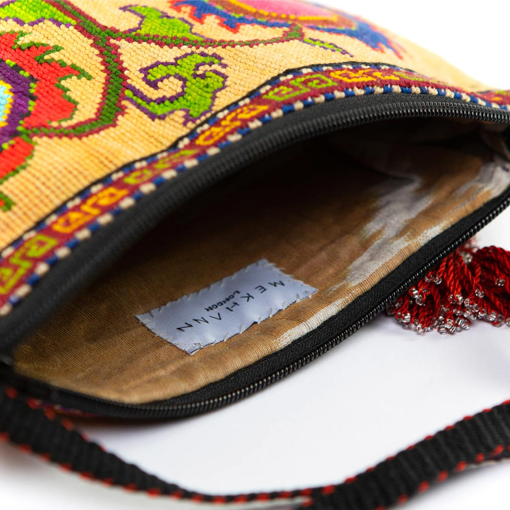 Inside view of Mekhann's beige botanical embroidered cross-body bag, revealing the durable lining and spacious design.