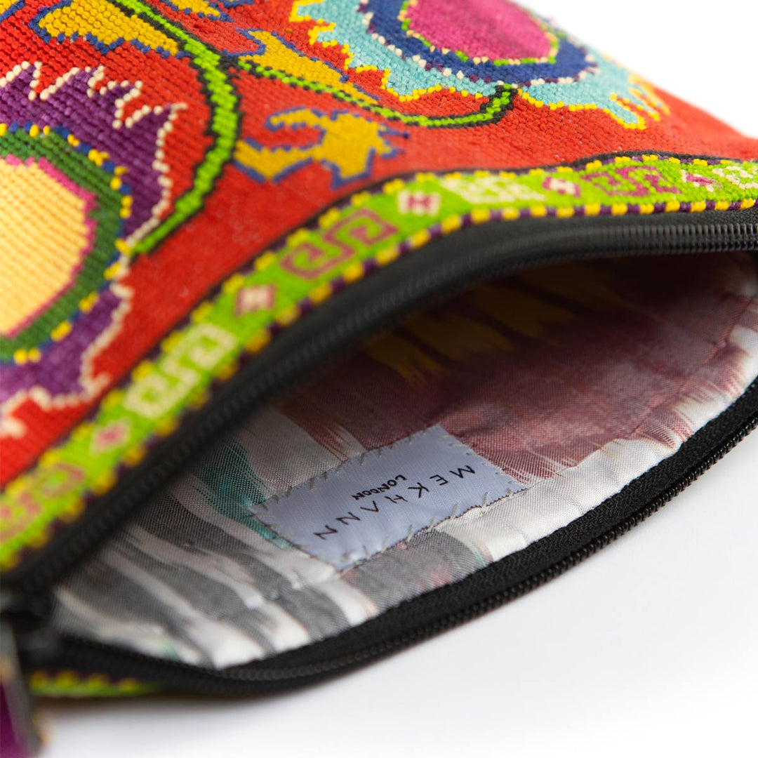 Inside view of Mekhann's red botanical embroidered cross-body bag, highlighting the durable lining fabric.