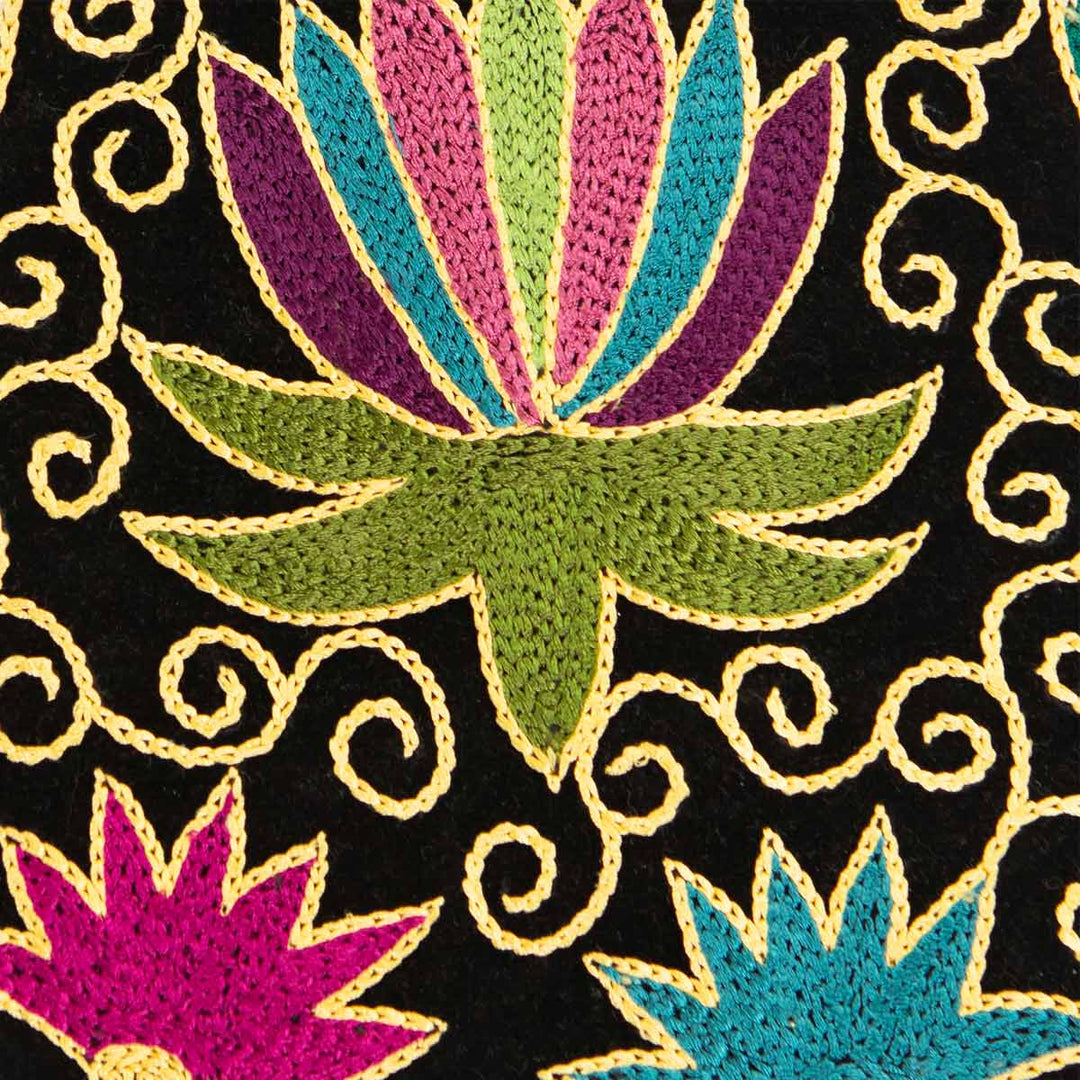 Close up view of Mekhann's botanical black velvet pouch, showing the attention to detail and intricate design of the flower motifs. 